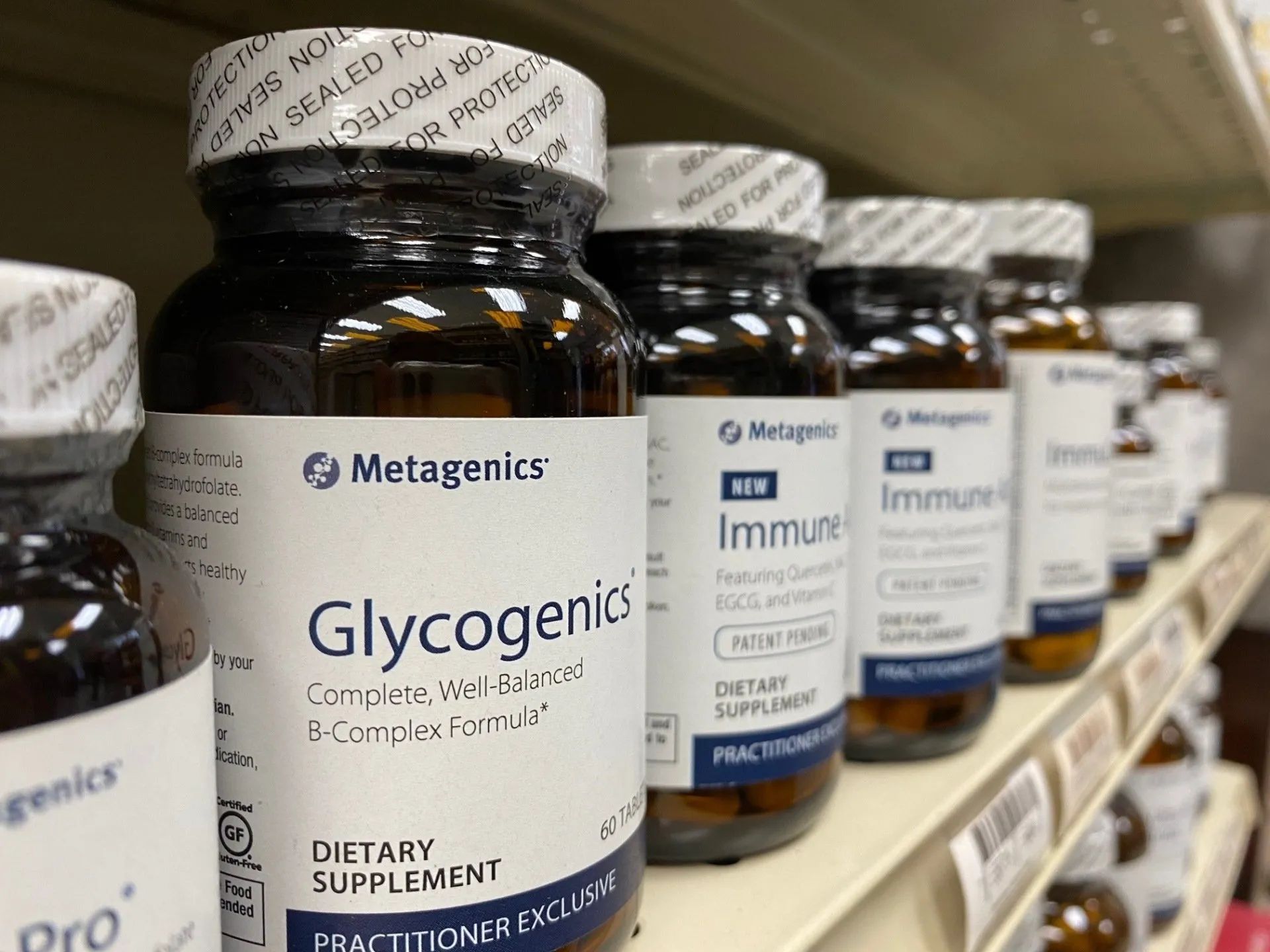 A Shelf Filled With Bottles of Glycogenic Dietary Supplements