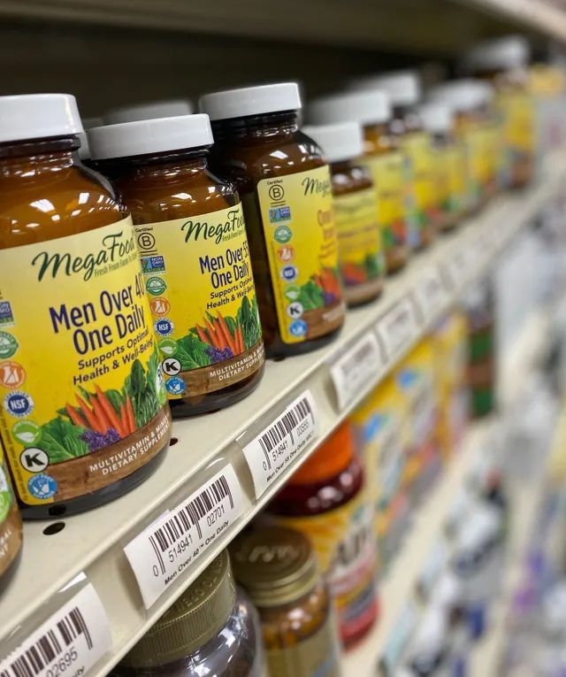 A Shelf Filled With Bottles of Men Over One Dash