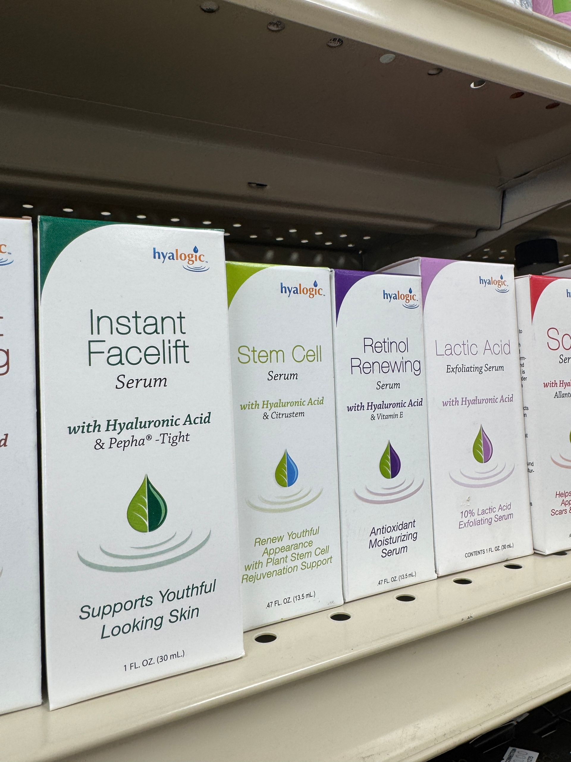 A shelf filled with boxes of instant facelift serum