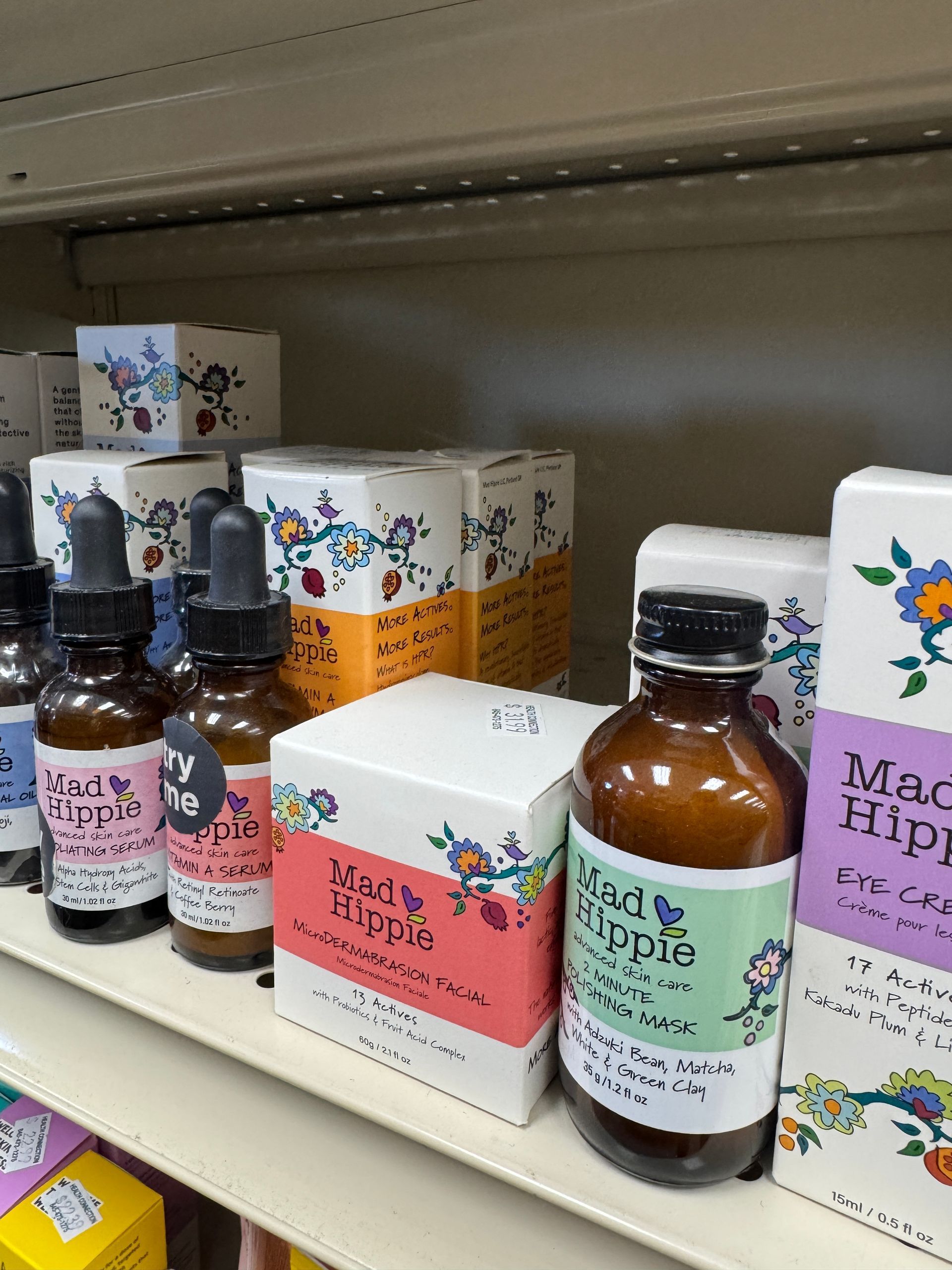 A shelf filled with bottles and boxes of mad hippie products