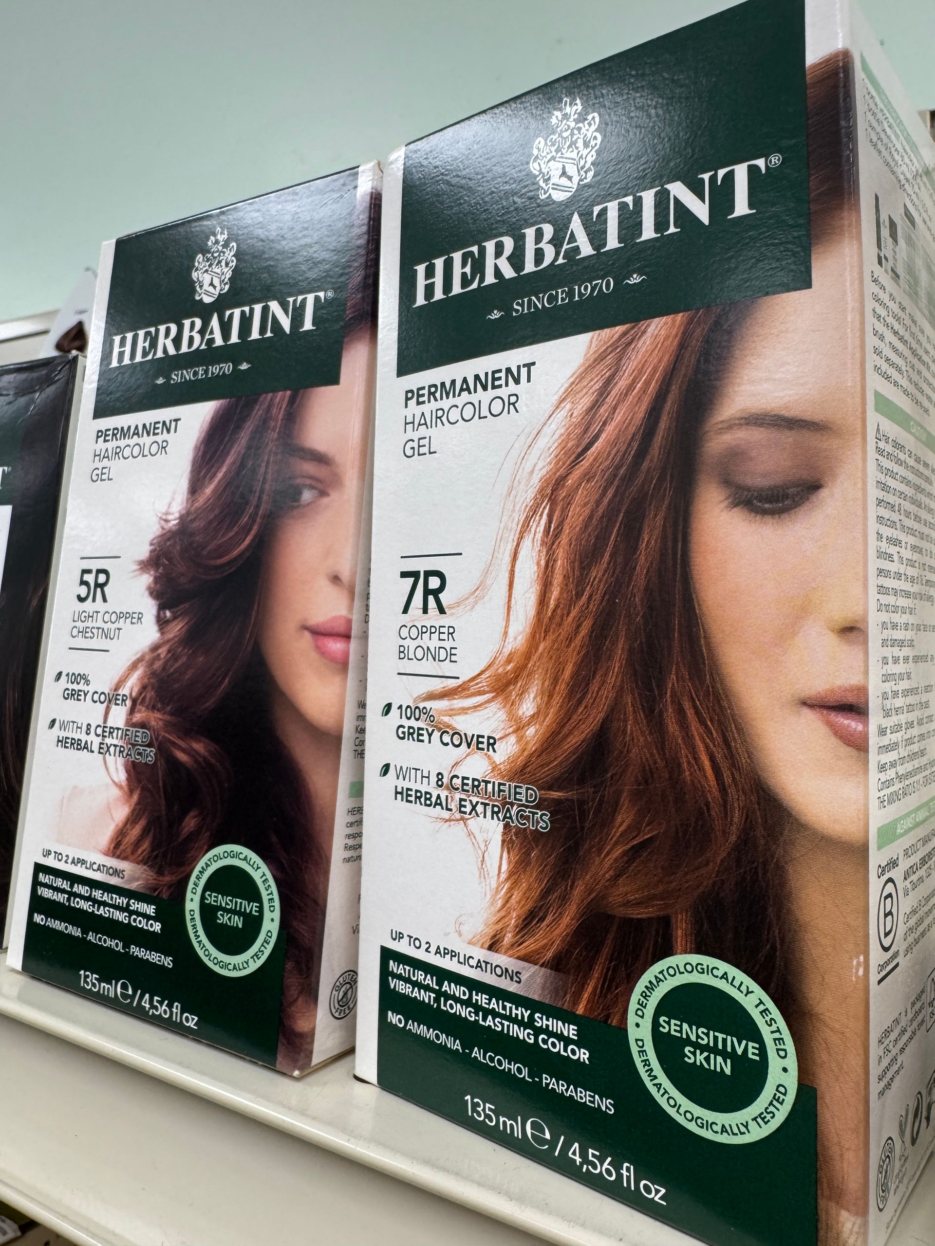 Two boxes of herbatint hair color are on a shelf