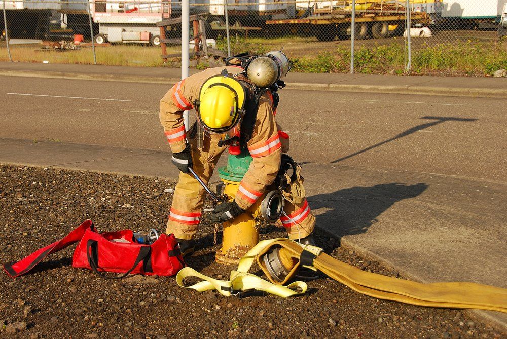 Fire Fighter Working on a Fire Hydrant — Fire Protection Services in Goonellabah, NSW