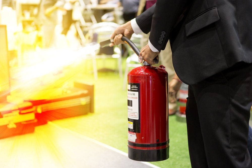 Using Fire Extinguisher to Fighting Fire — Fire Protection Services in Murwillumba, NSW