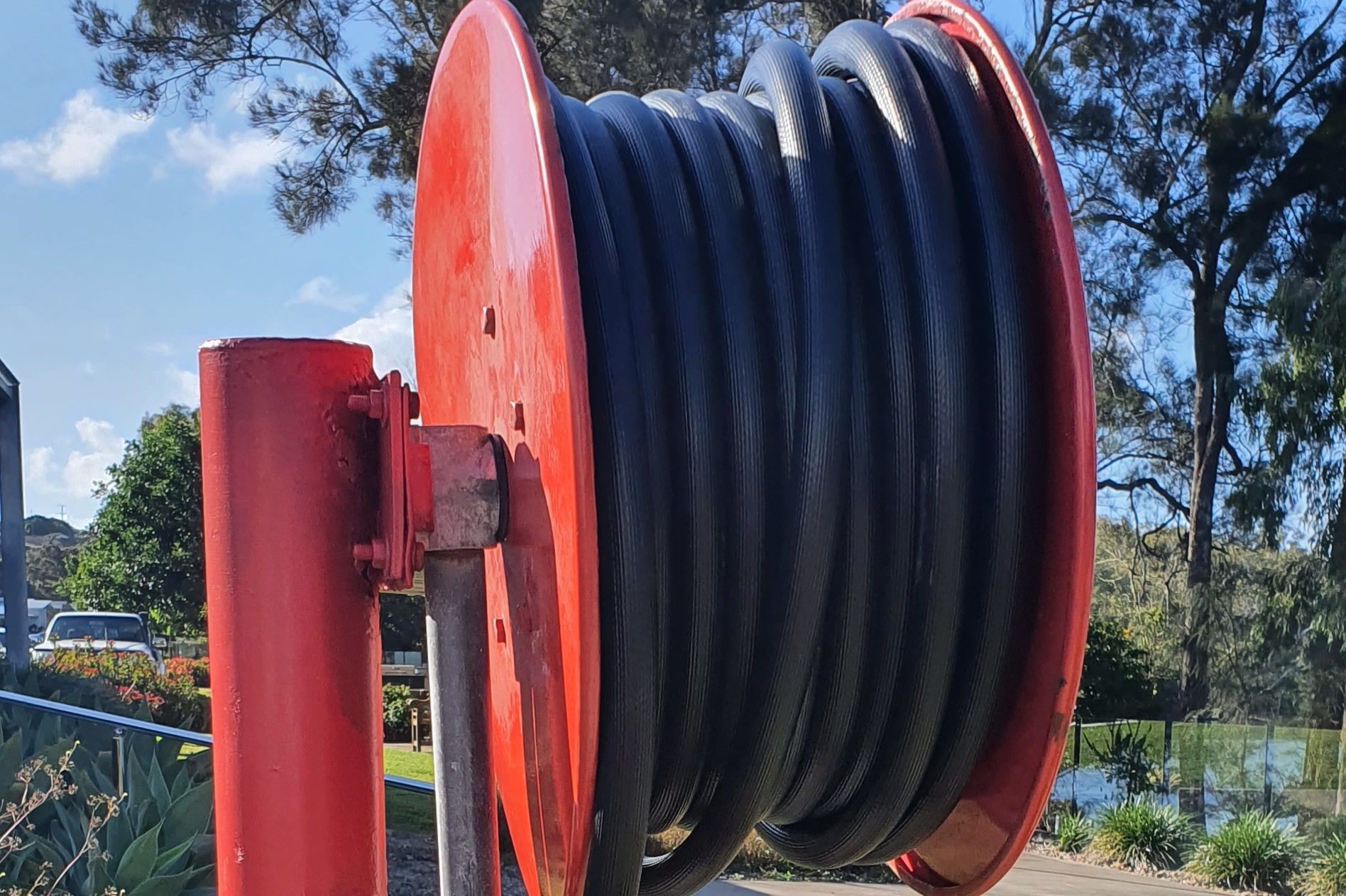 Fireman With a Rolled Fire Hose — Fire Protection Services in Goonellabah, NSW