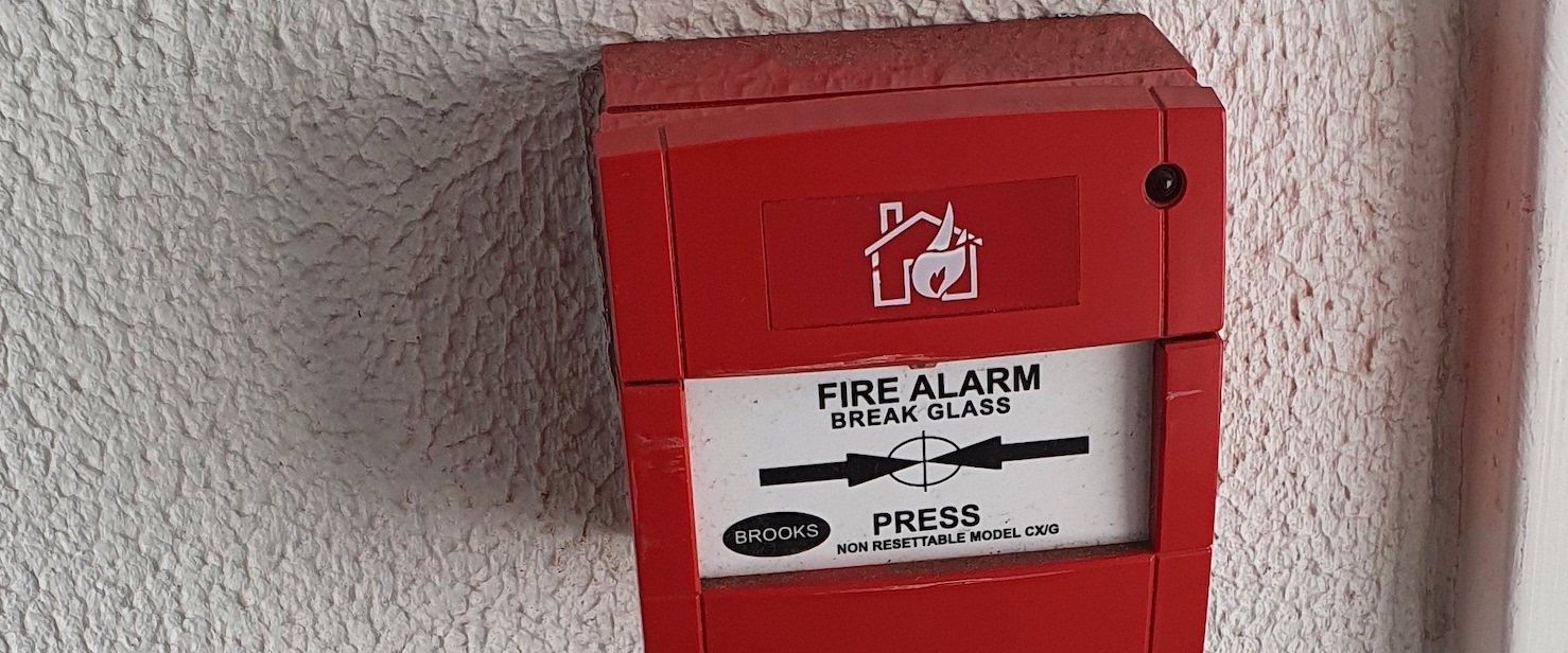 Man Checking Labels of Fire Extinguisher — Fire Protection Services in Goonellabah, NSW