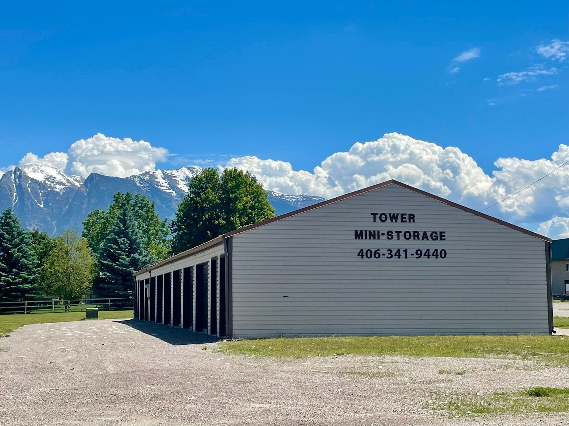 A tower mini storage building with mountains in the background