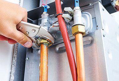 Plumber Repairing A Gas Boiler — Plumbing Solution in Orange, NSW