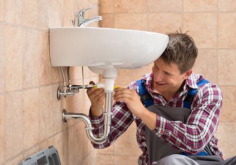 Plumber Fixing The Sink — Plumbing Solution in Orange, NSW