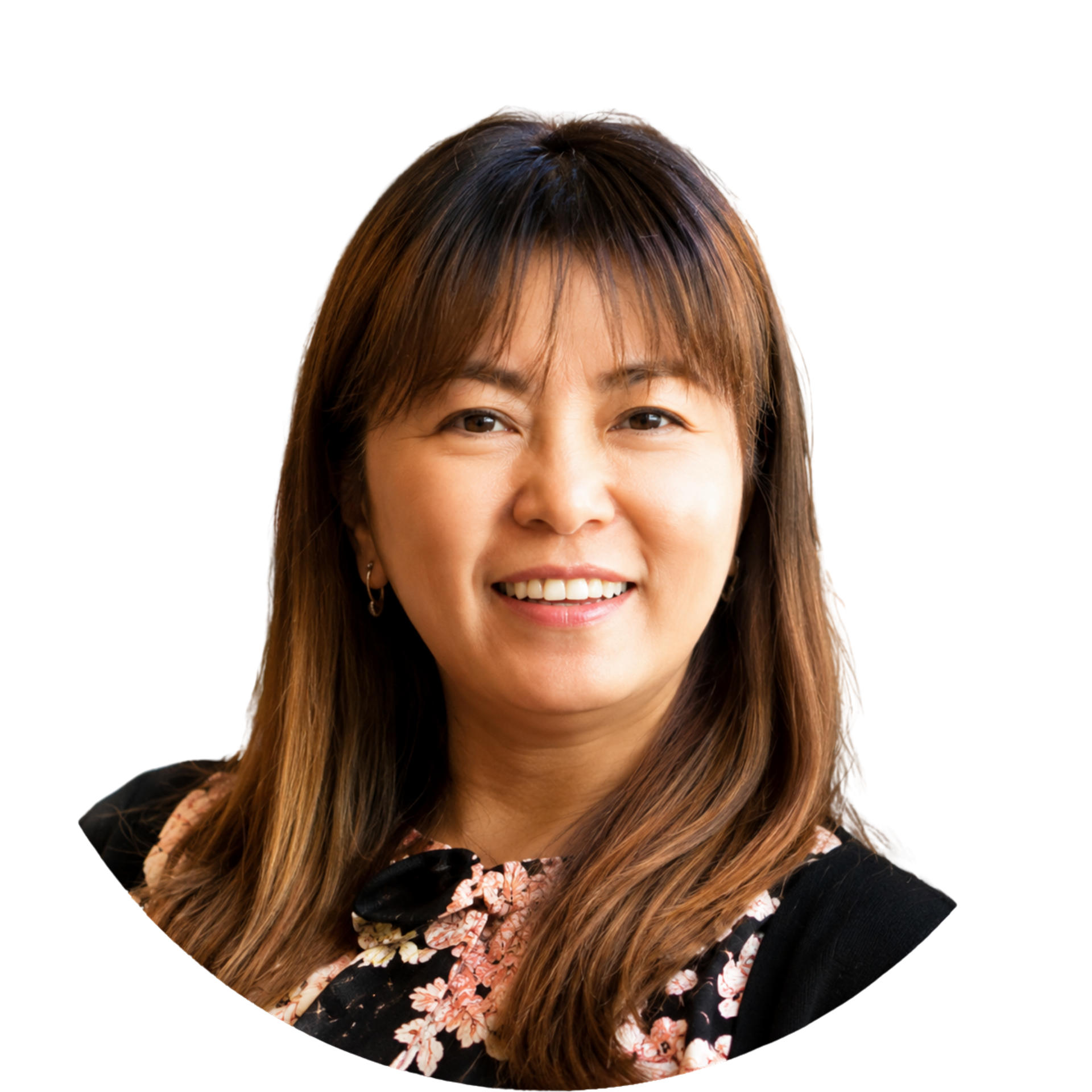 Smiling woman with shoulder-length brown hair in a black floral top on a white background