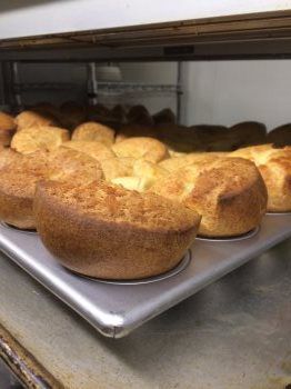A bunch of bread is sitting on a tray in an oven.