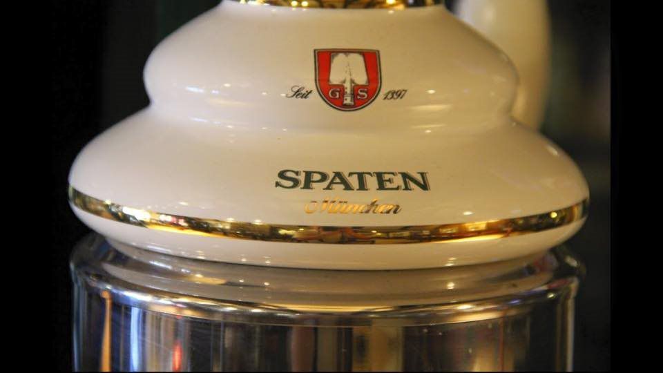 A white ceramic container with spaten written on it
