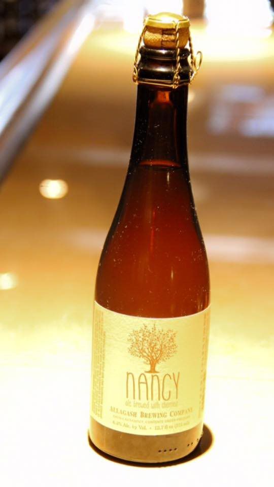 A bottle of nancy beer is sitting on a counter