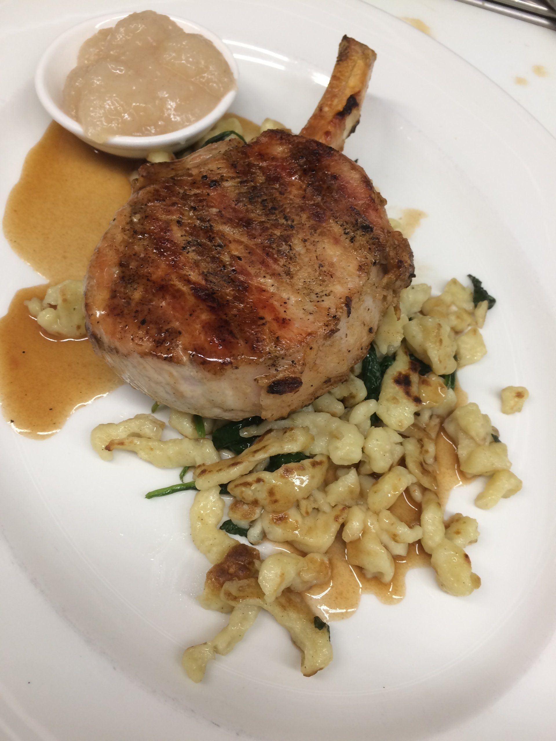 A close up of a plate of food with meat and pasta