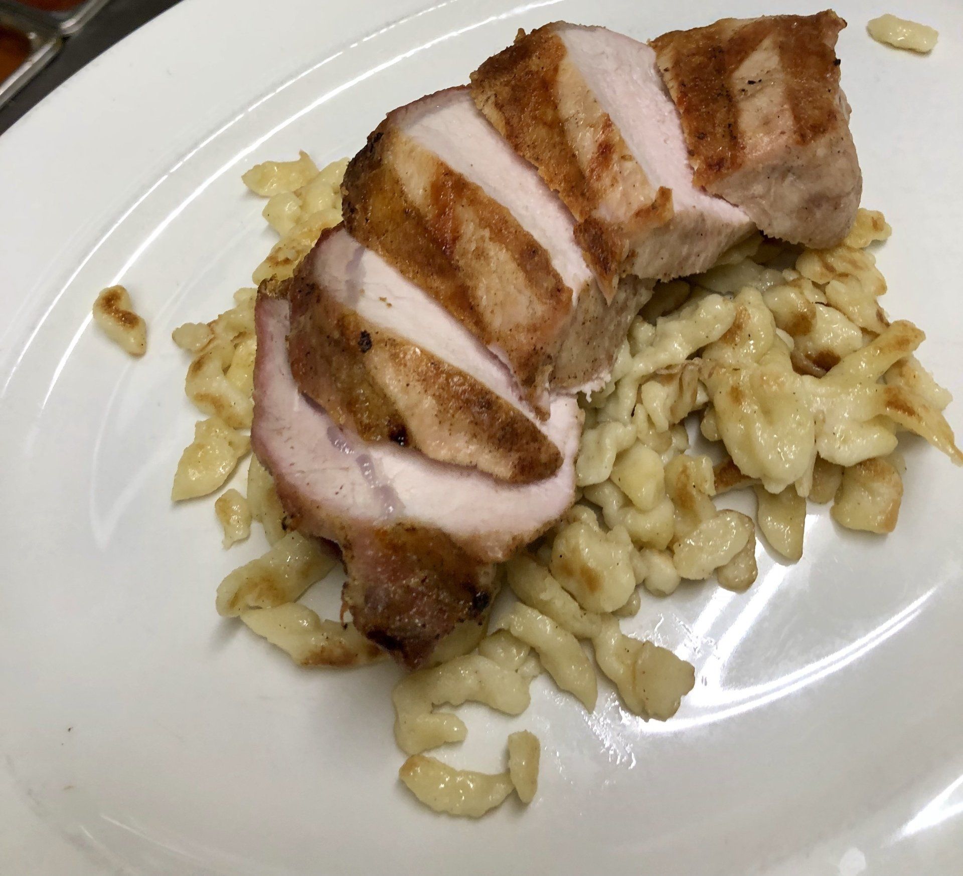 A plate of food with meat and pasta on it