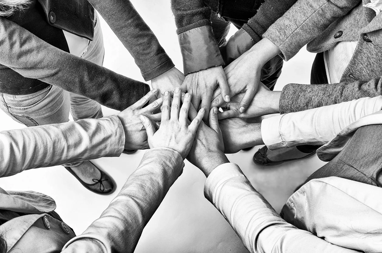 Photo of hands of a circle of volunteers