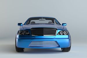 Blue sedan, head-on view, chrome grille, against a light grey background.
