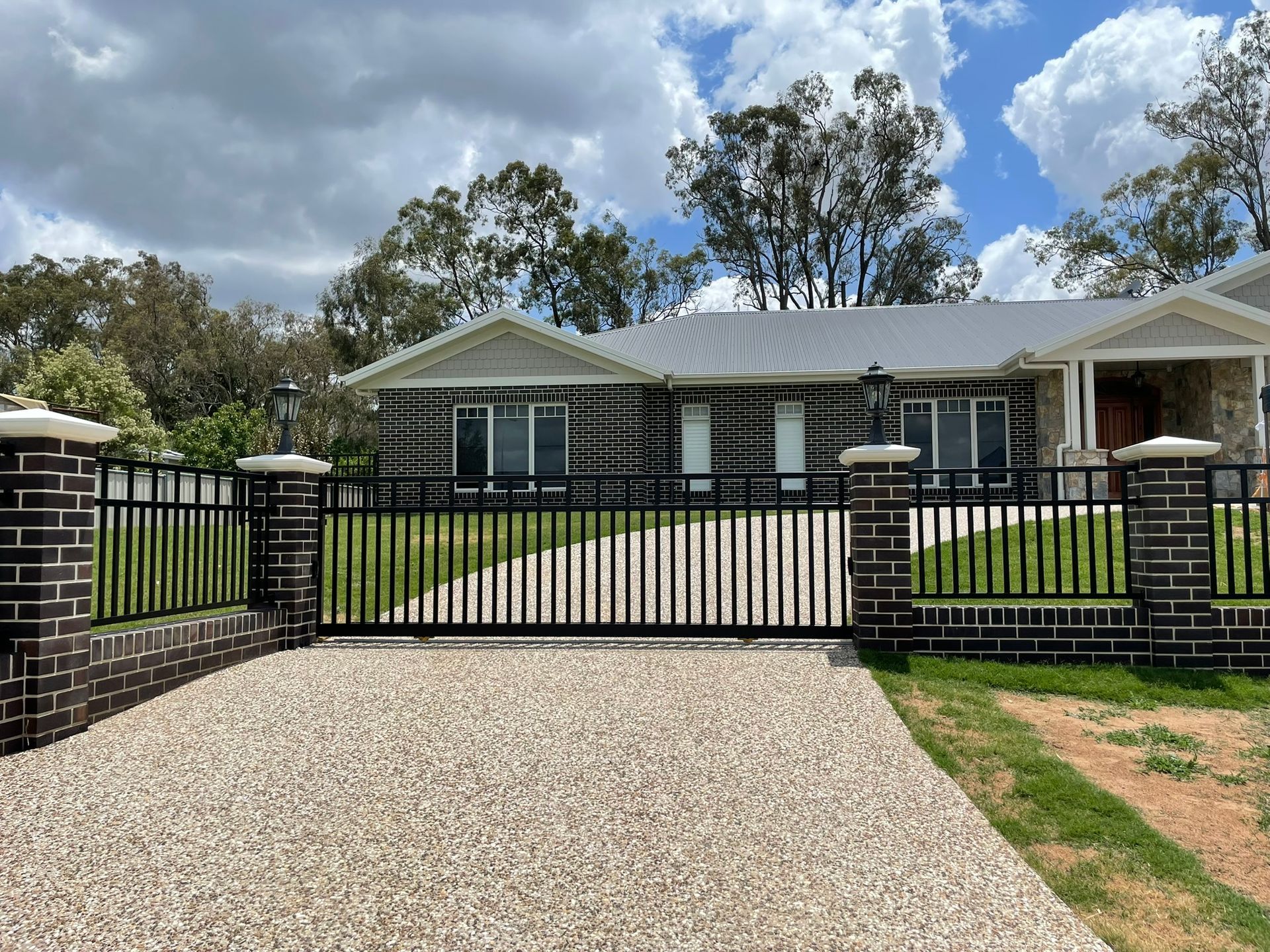 A large house with a driveway and a fence