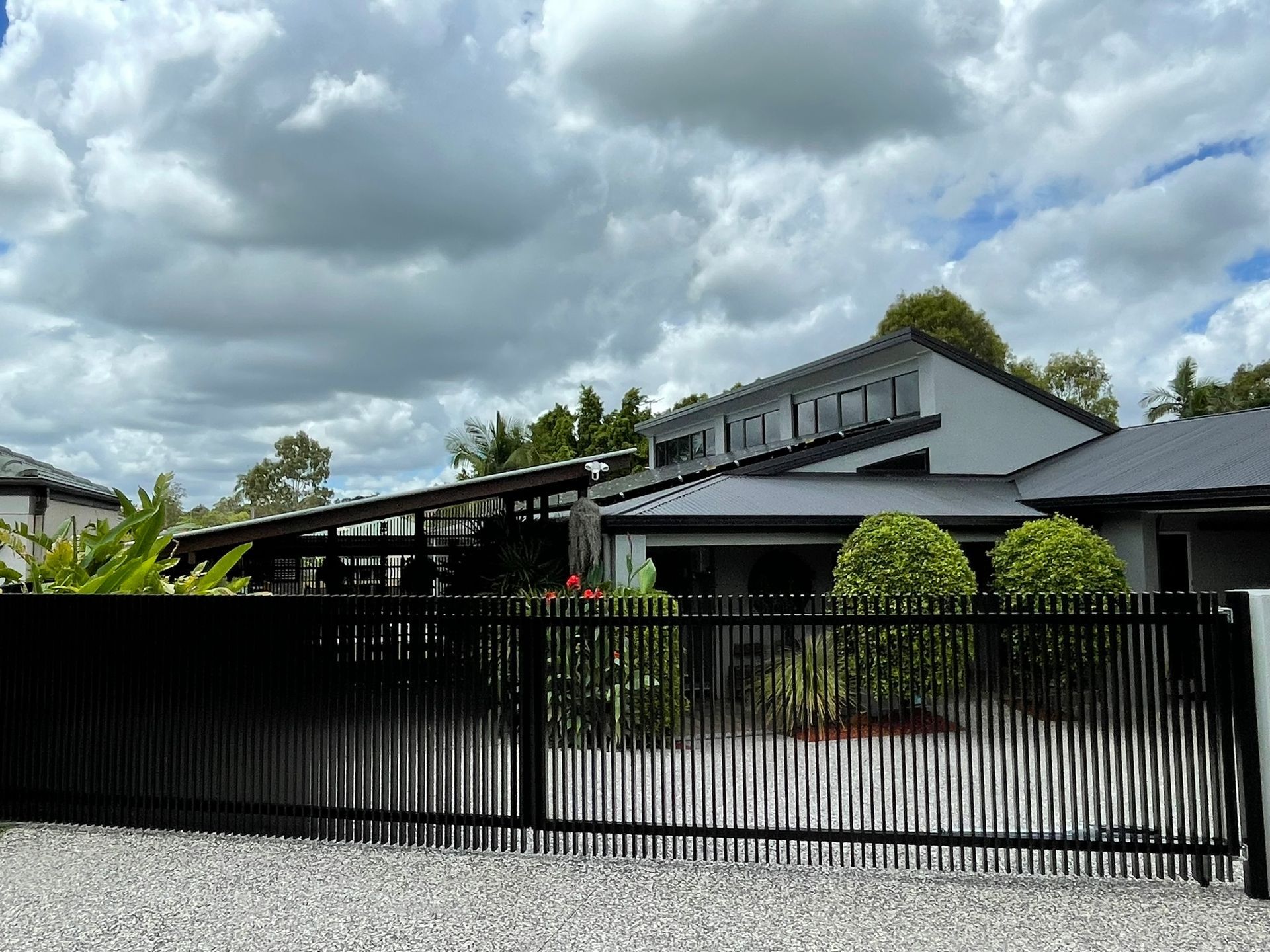 A large house with a black fence in front of it.