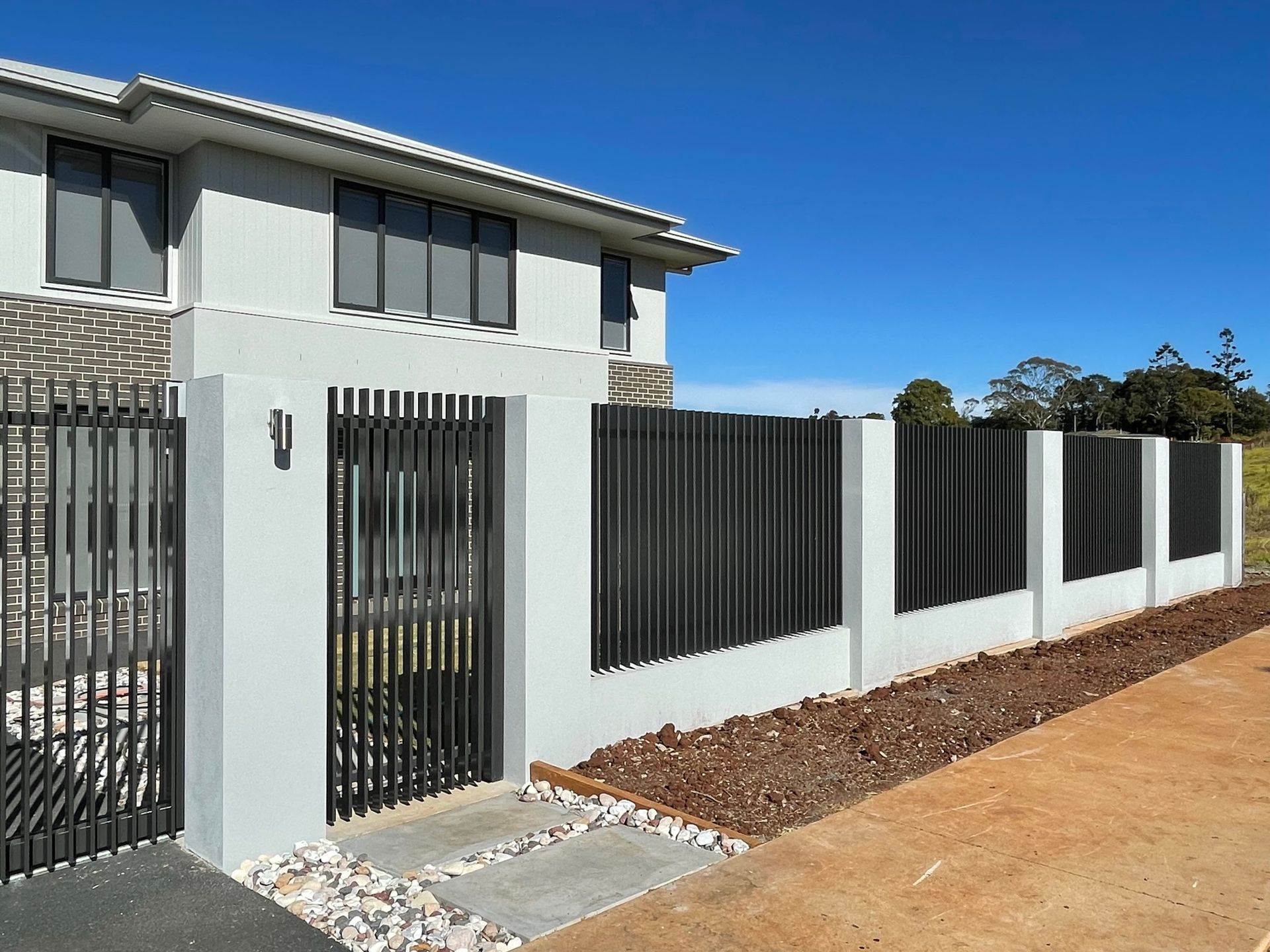 A white house with a black fence in front of it