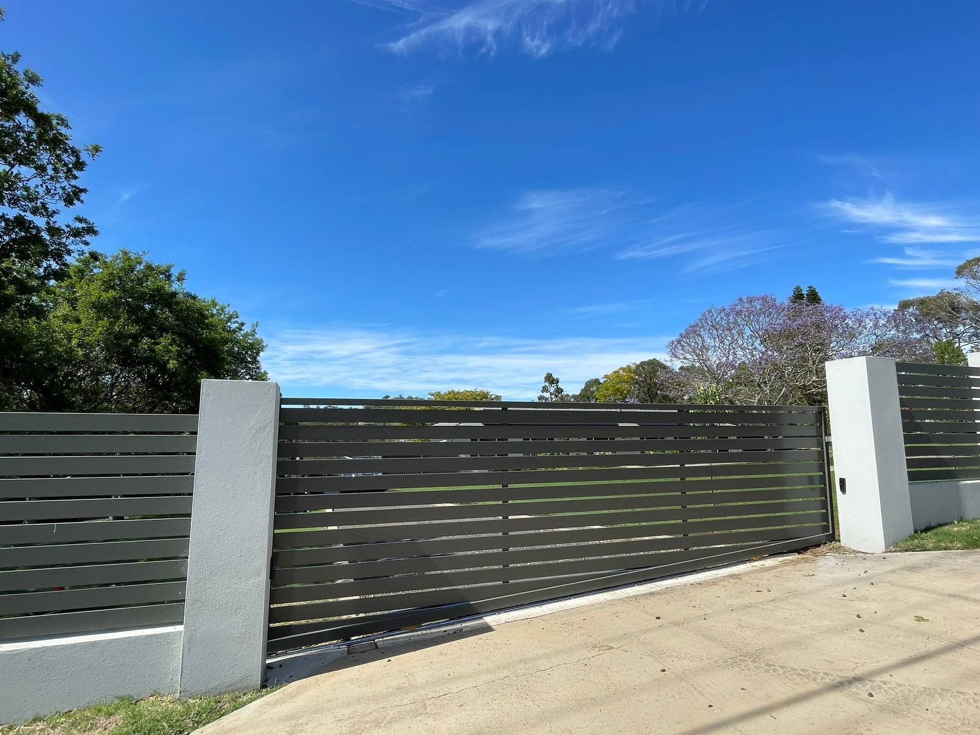 A fence with a blue sky in the background