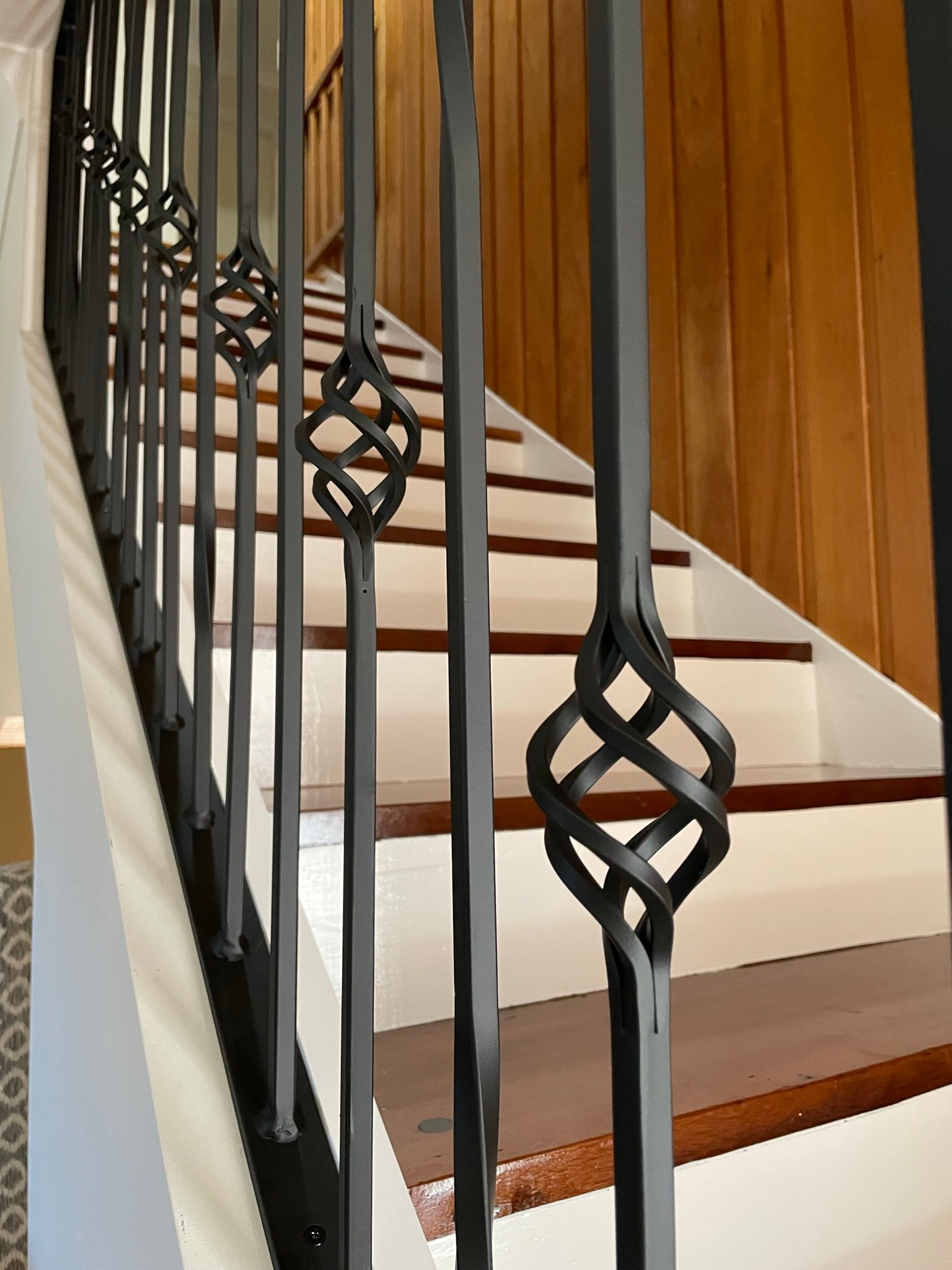 A close up of a wrought iron railing on a set of stairs
