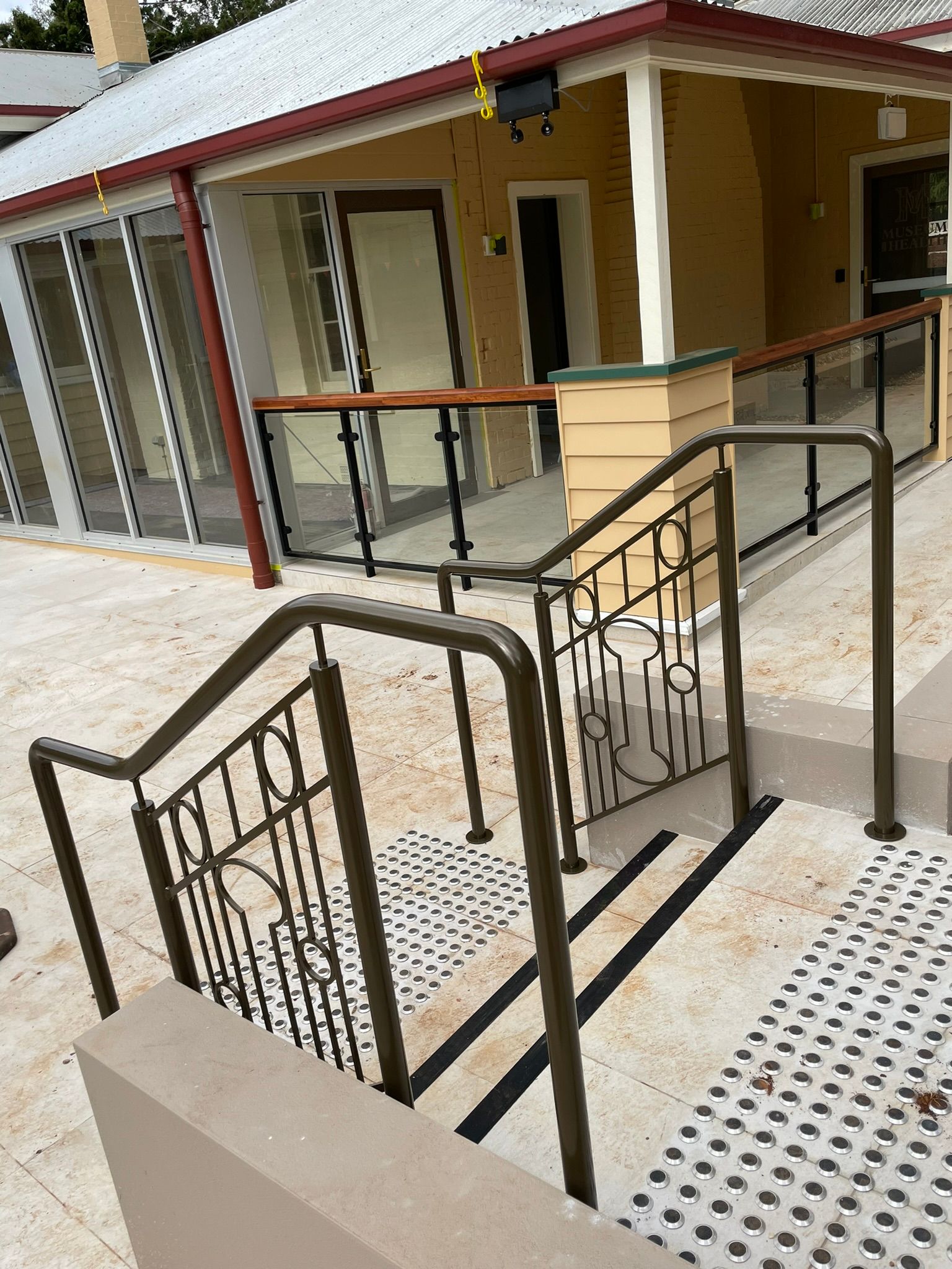 A set of stairs leading up to a house with a railing.