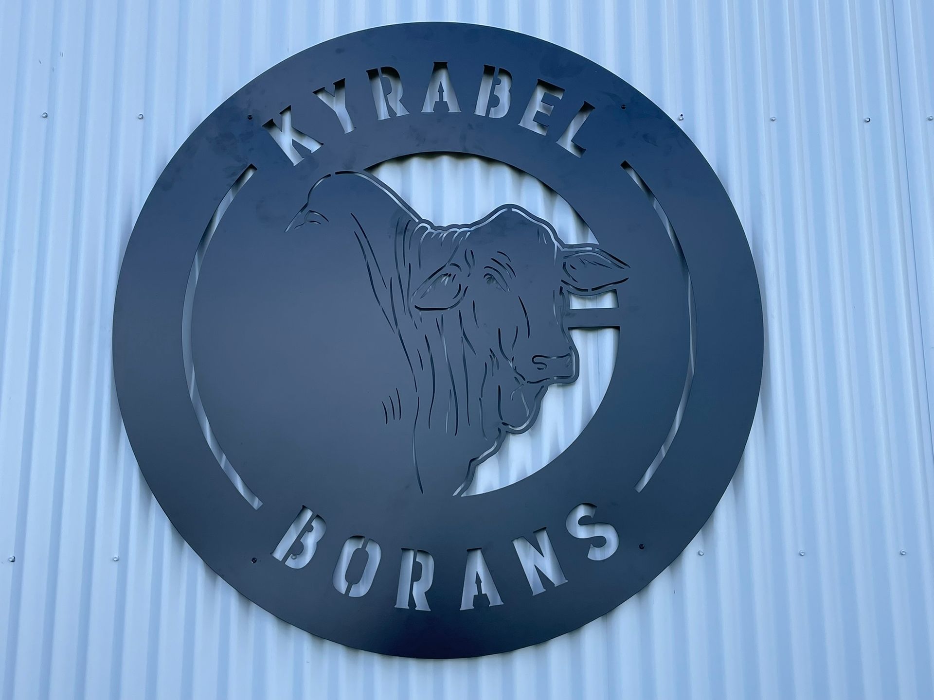 A laser cut sign on a wall that says kyrabel borans