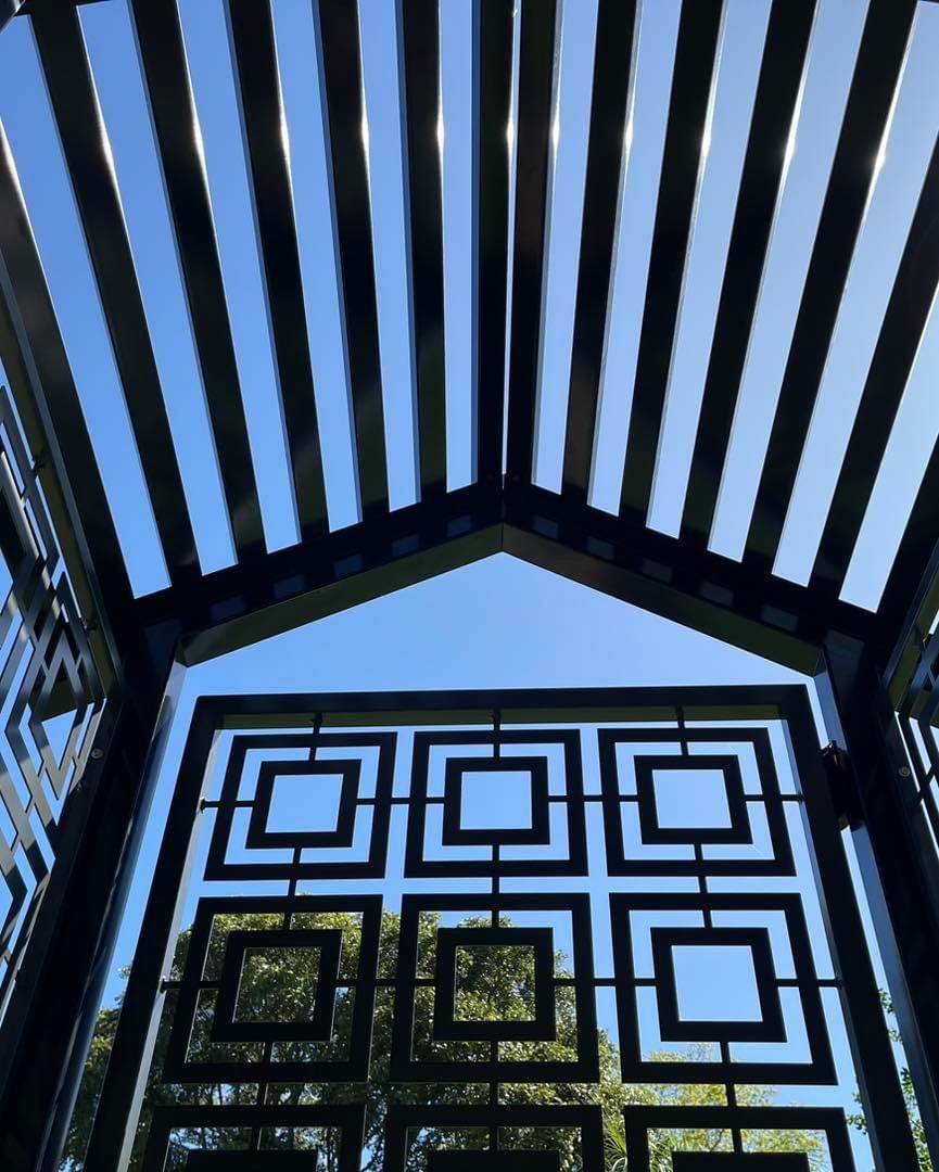 Looking up at a gate with a blue sky in the background