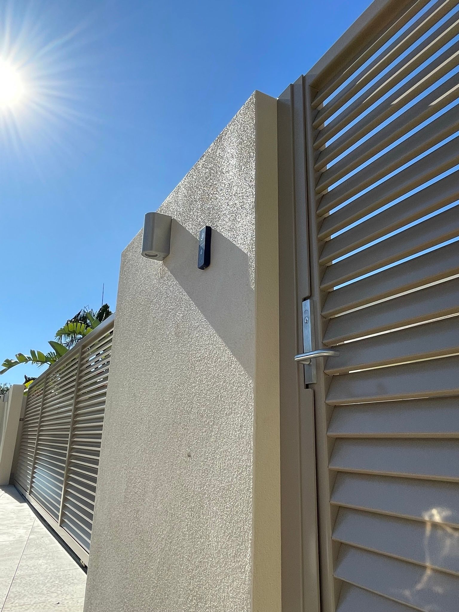 A close up of a gate with the sun shining through it.