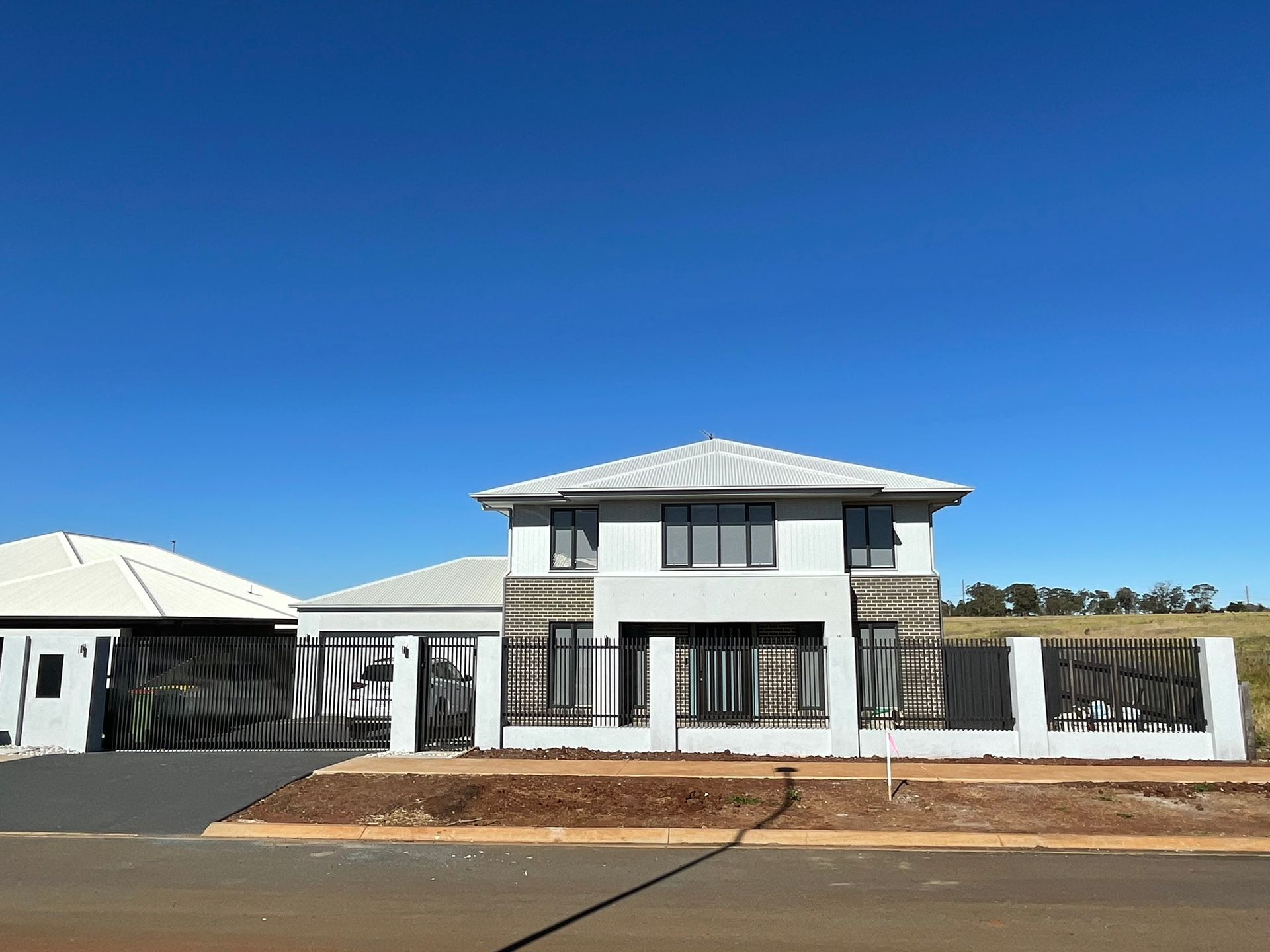 A large white house with a blue sky in the background
