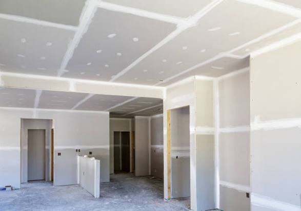 A room that is being remodeled with drywall on the walls and ceiling