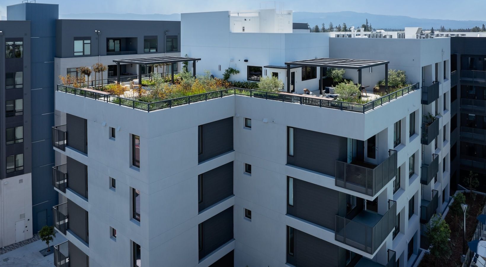 Modern apartment building at Sofia in Santa Clara with rooftop terraces and greenery.