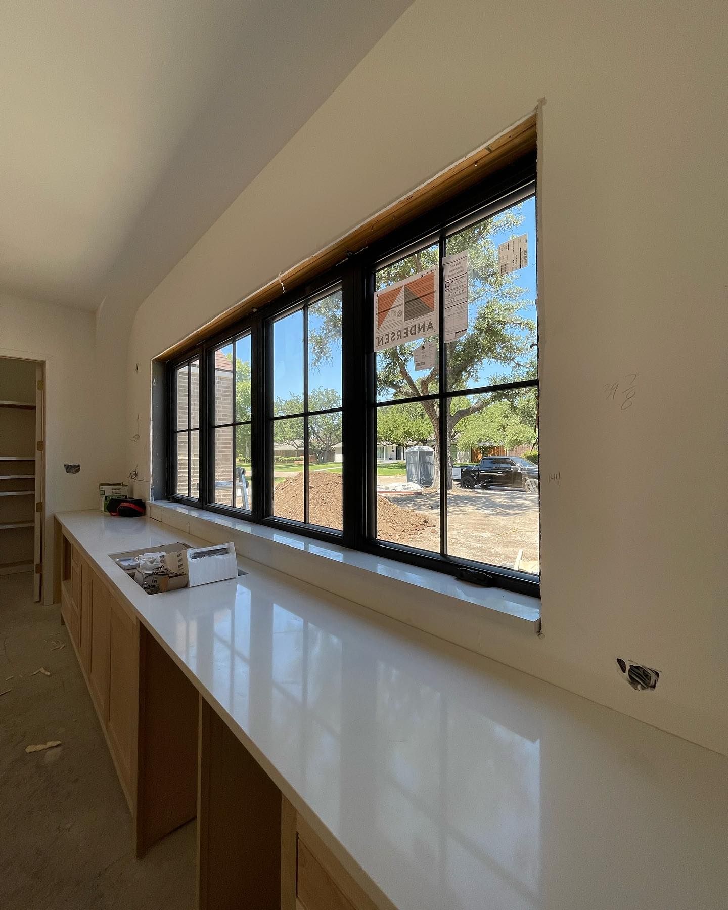 A kitchen with a lot of windows and a counter top.