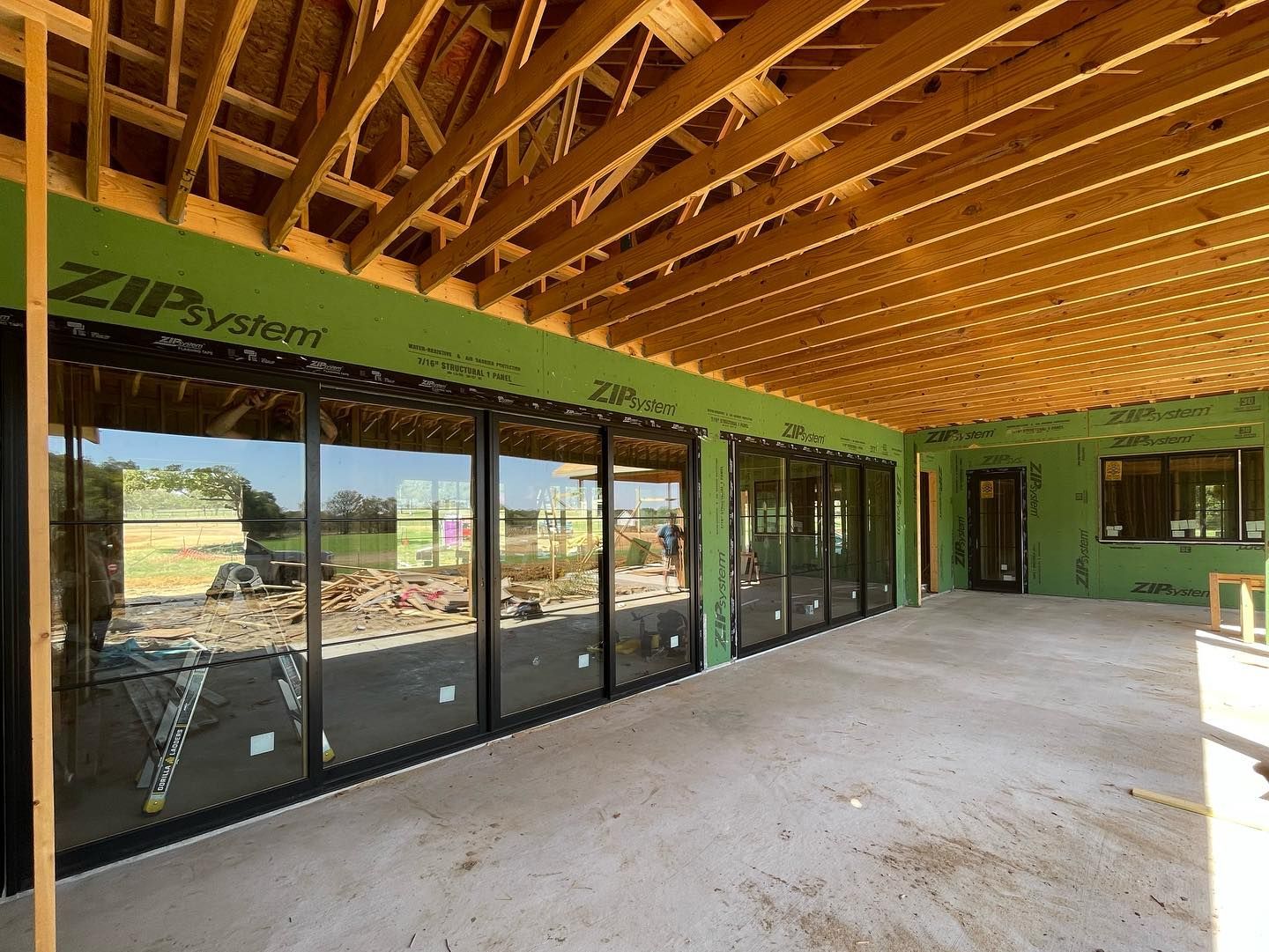 A building under construction with a lot of windows and a wooden ceiling.