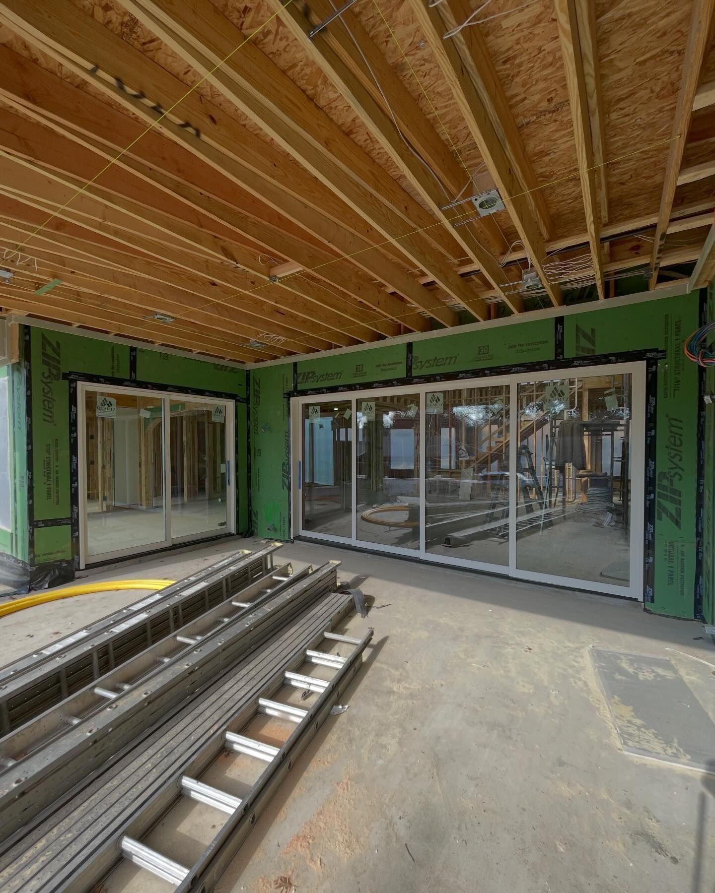 A building under construction with a lot of windows and a ladder