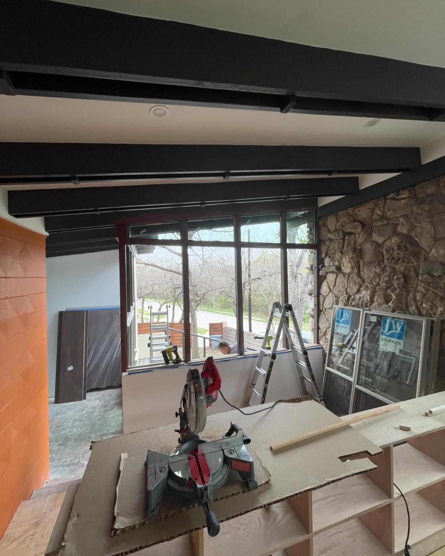 A circular saw is sitting on top of a wooden table in a room.