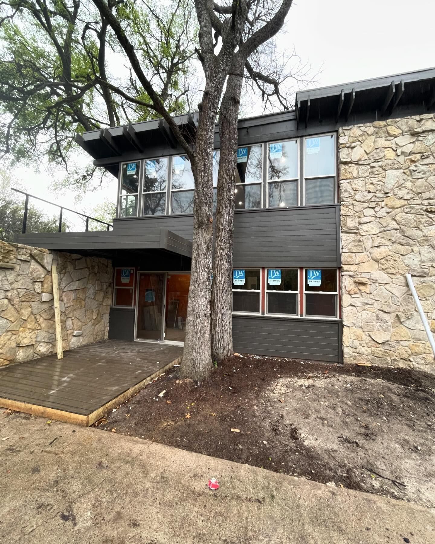 A large stone building with a tree in front of it.