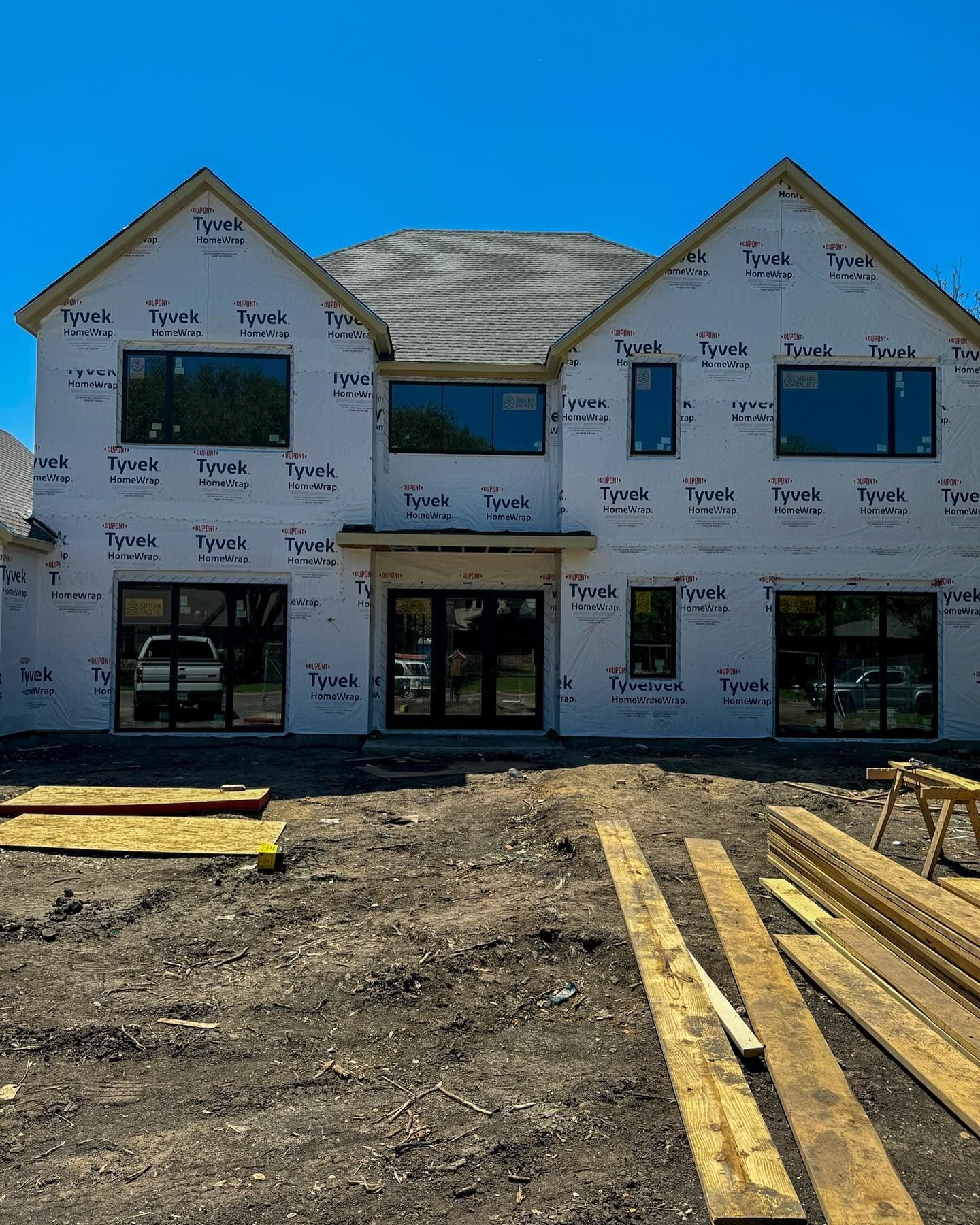 A large house is being built with a lot of windows.