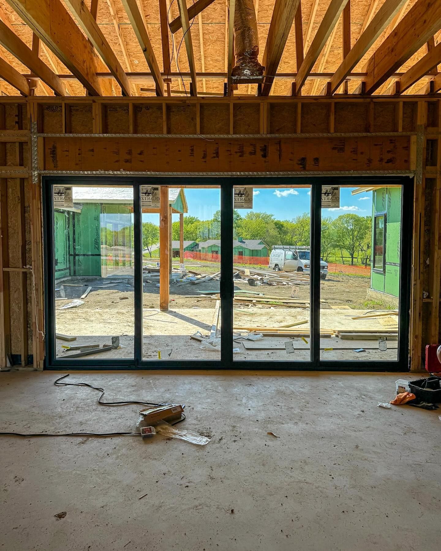 A large sliding glass door in a building under construction