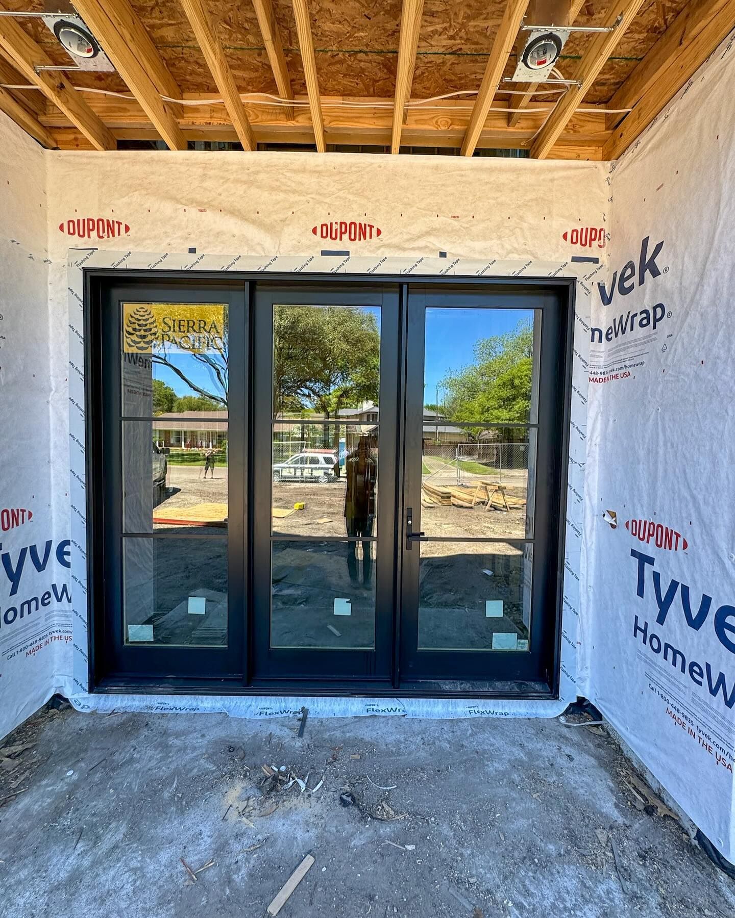 A door is being installed in a house under construction.