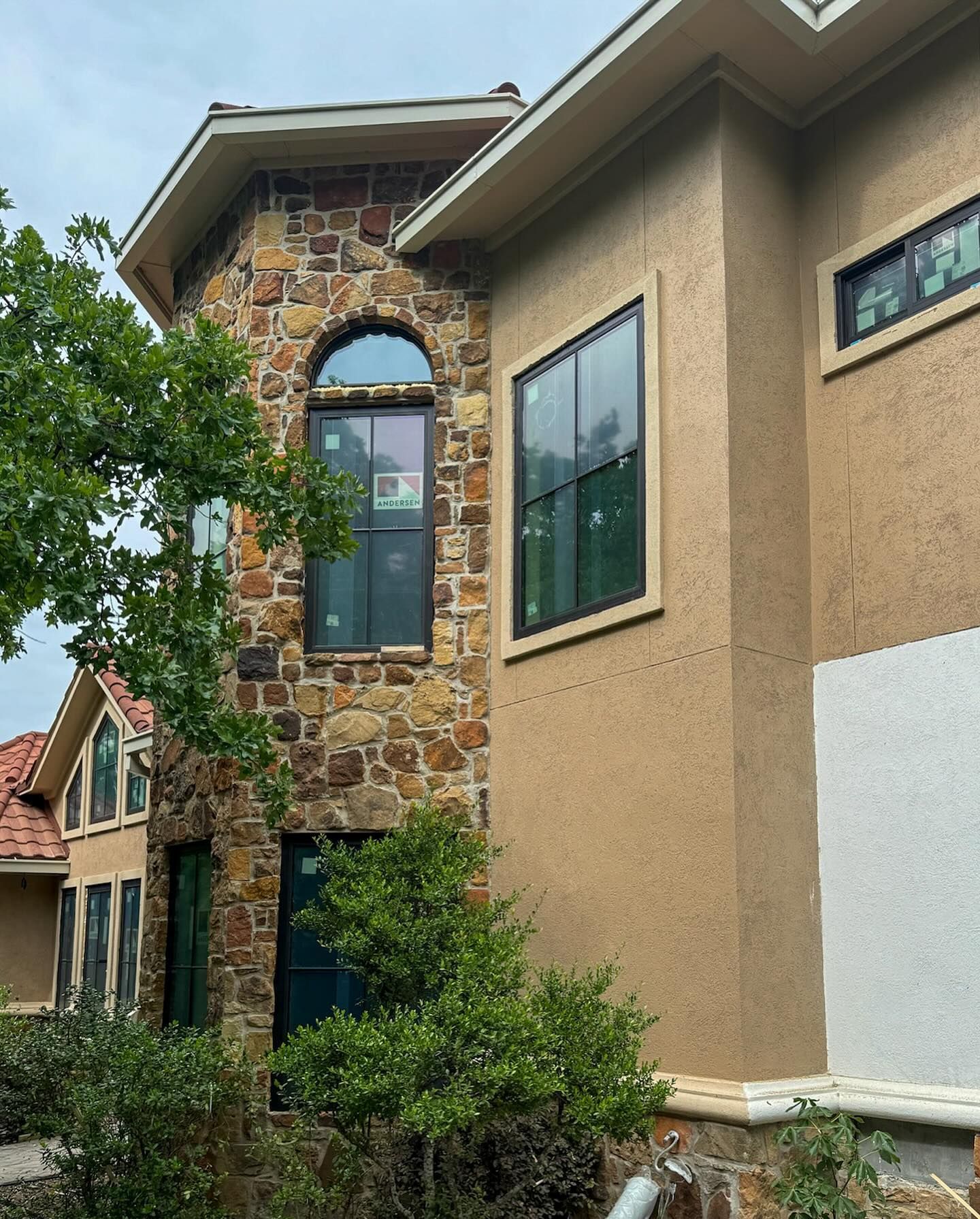 A house with a stone facade and a lot of windows