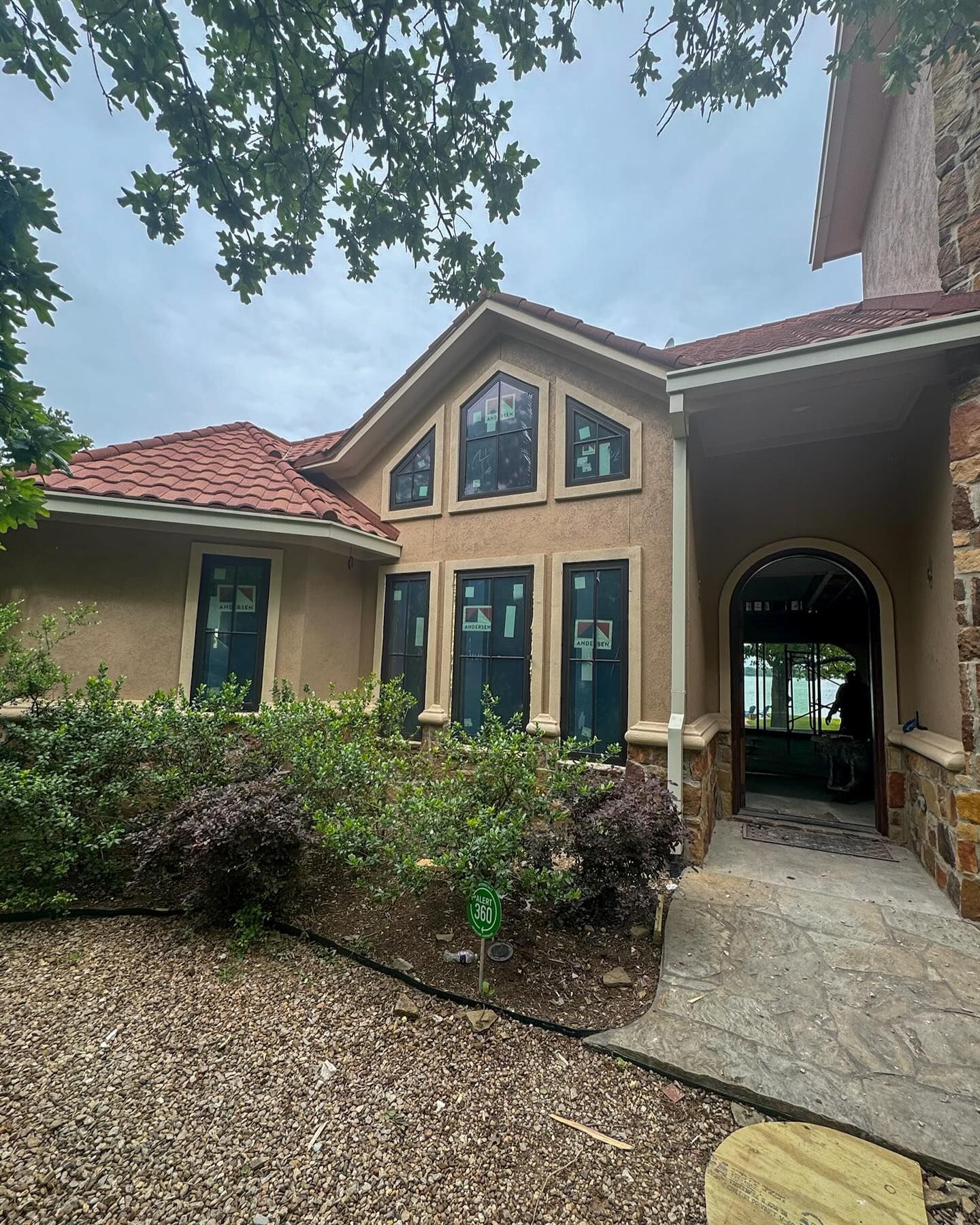 A large house with a lot of windows is being built.