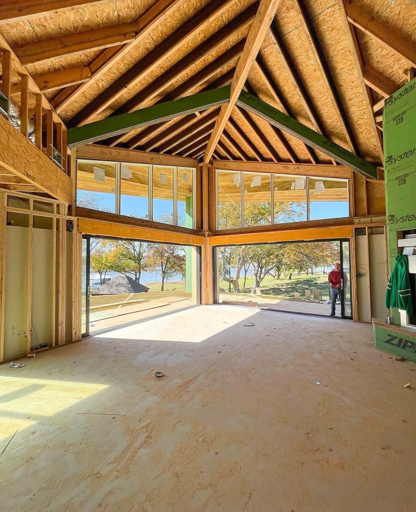 A large room with a lot of windows and a wooden ceiling.