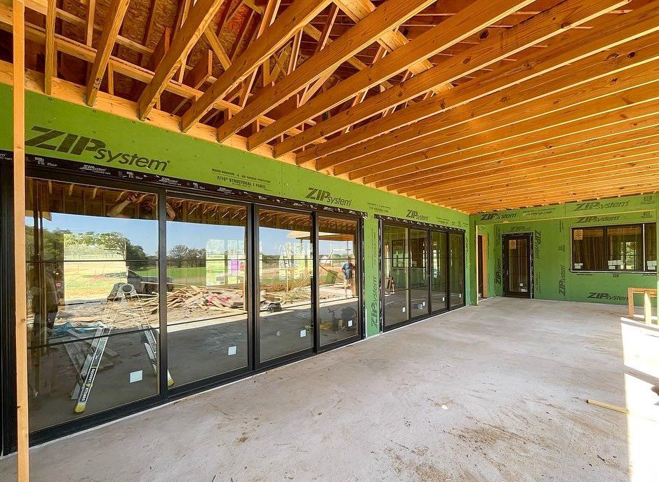 A building under construction with a lot of windows and a wooden ceiling.