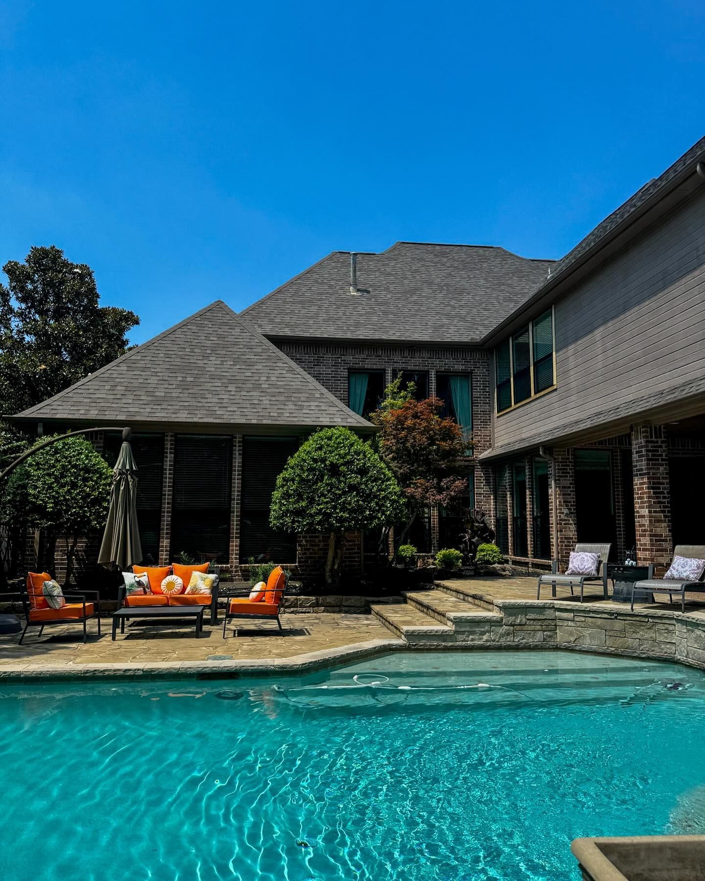 A large house with a large swimming pool in front of it.