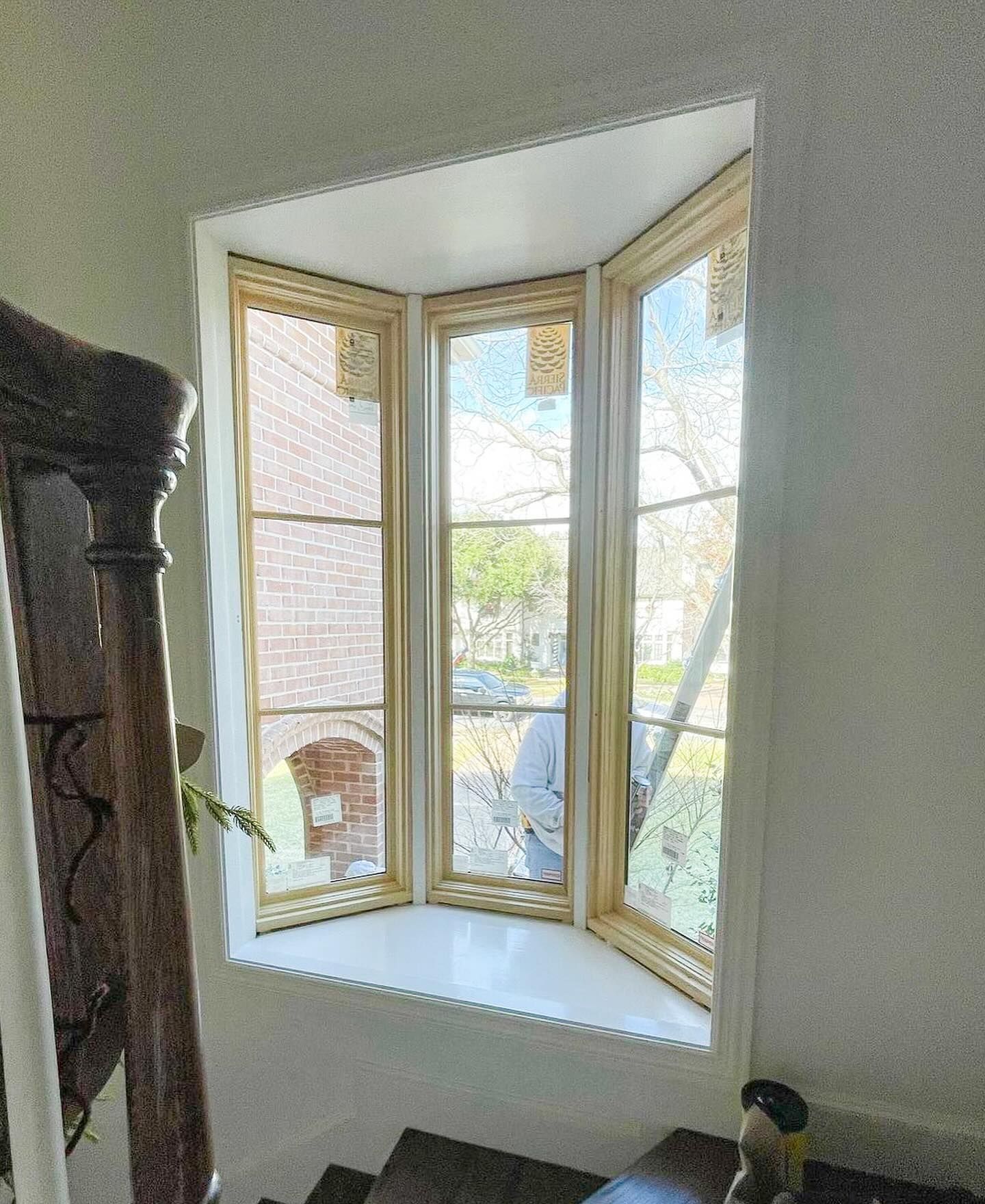 A bay window in a room with stairs leading up to it.