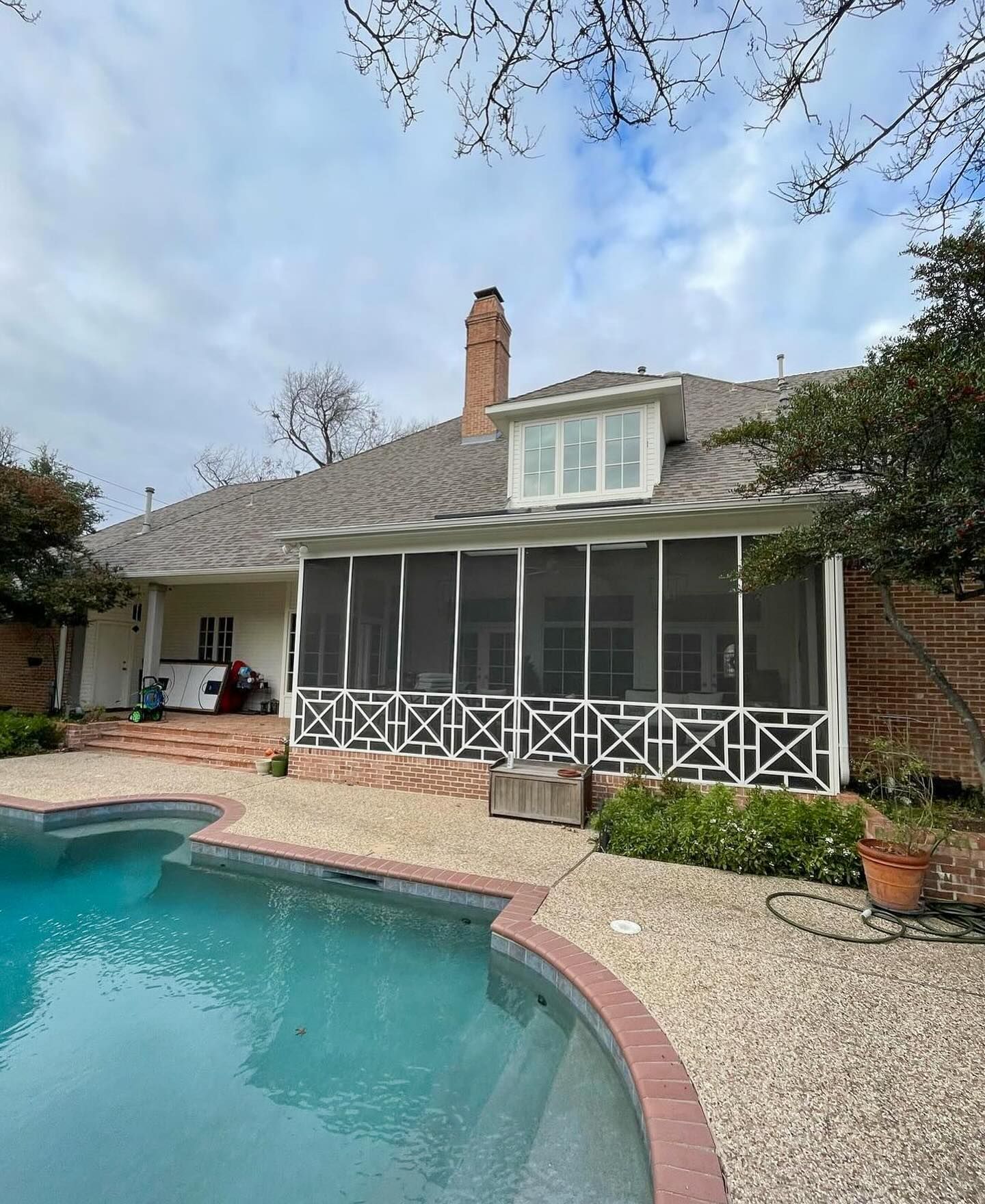A house with a screened in porch and a swimming pool