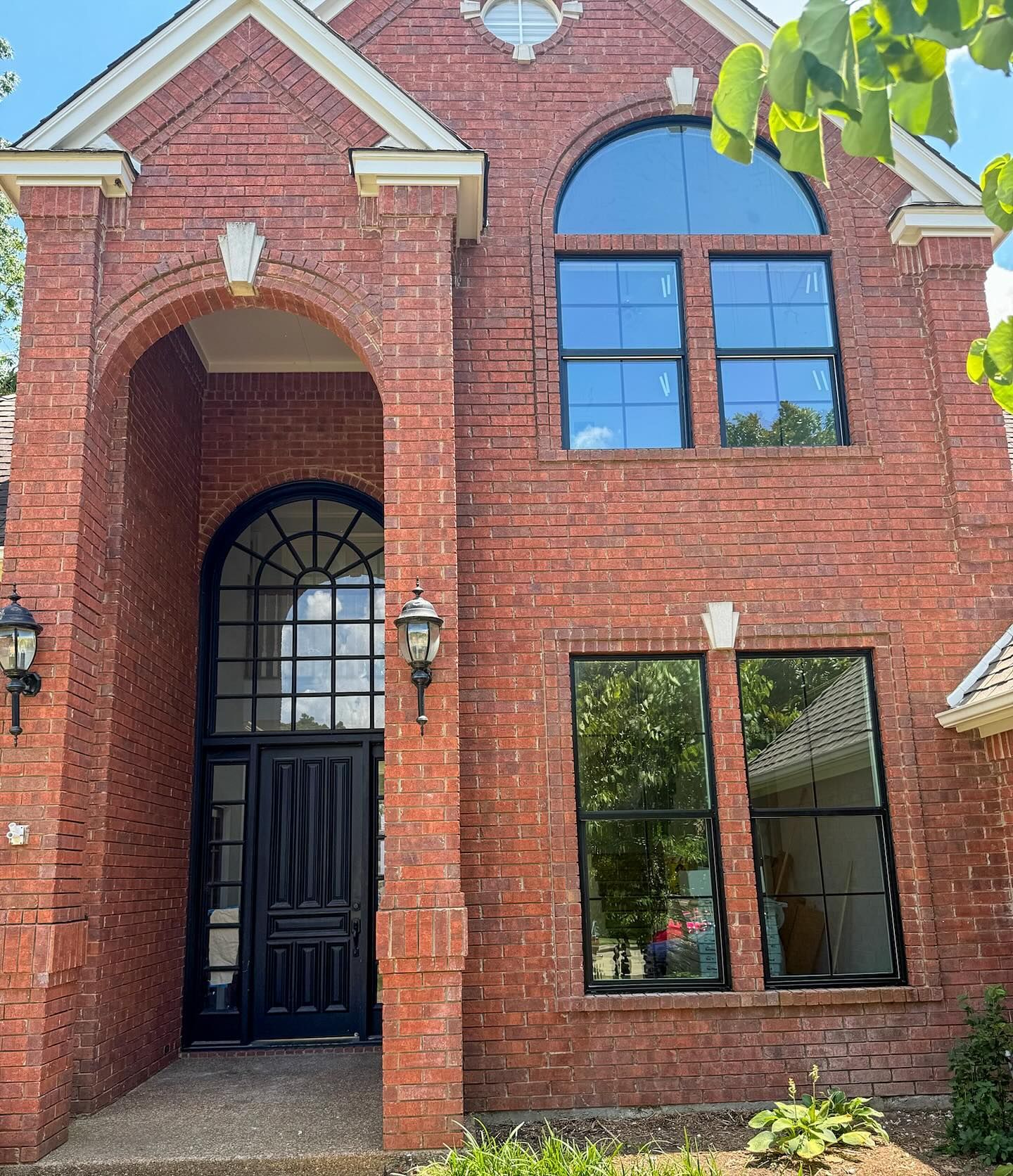 A brick house with a black door and windows