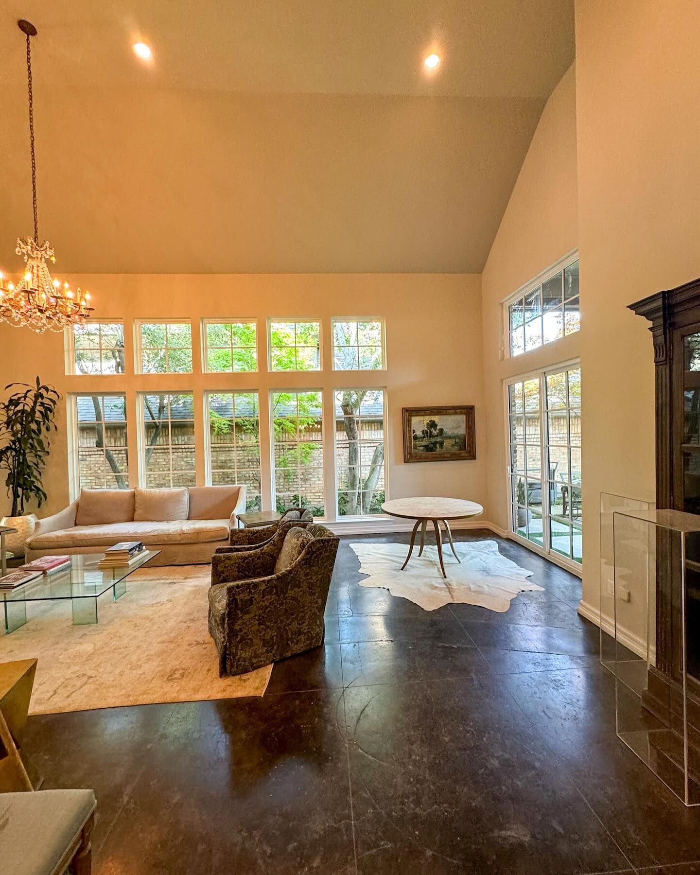 A living room with a vaulted ceiling and lots of windows