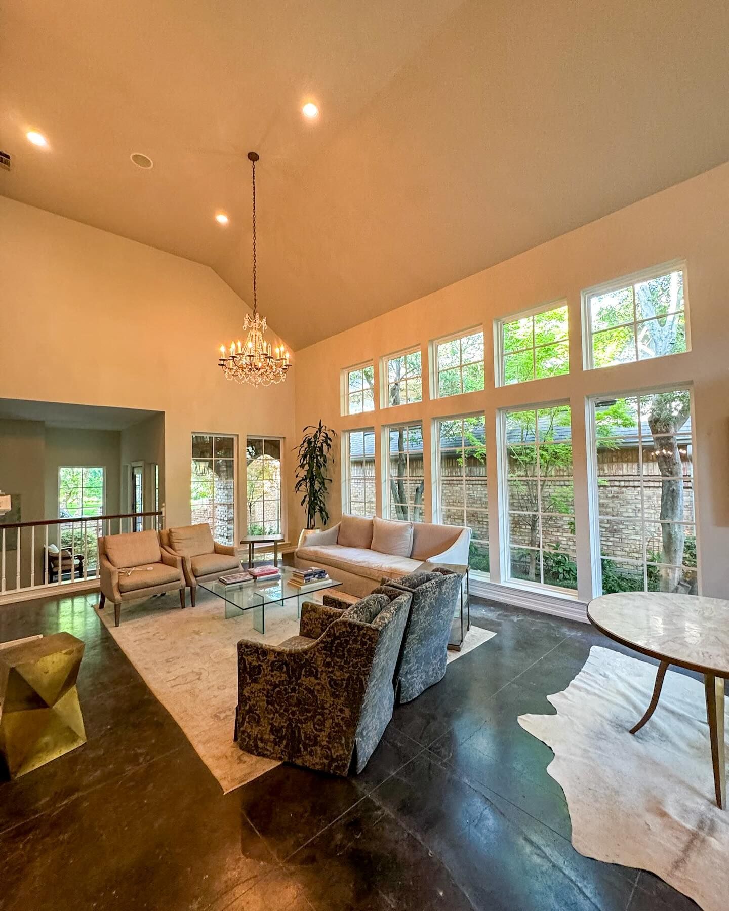 A living room with a lot of windows and furniture